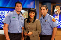 Liz poses with firefighters